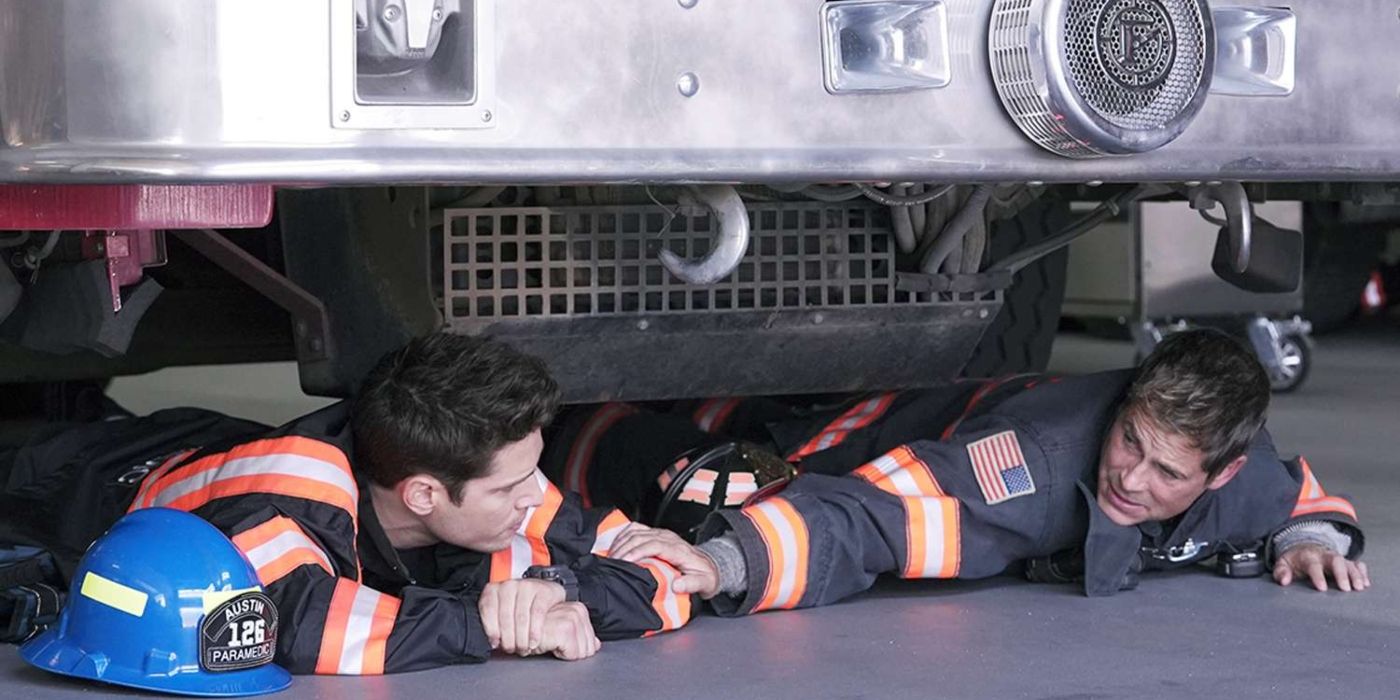 TK and Owen in their fire gear, lying underneath a fire engine in &lsquo;9-1-1: Lone Star&rsquo;