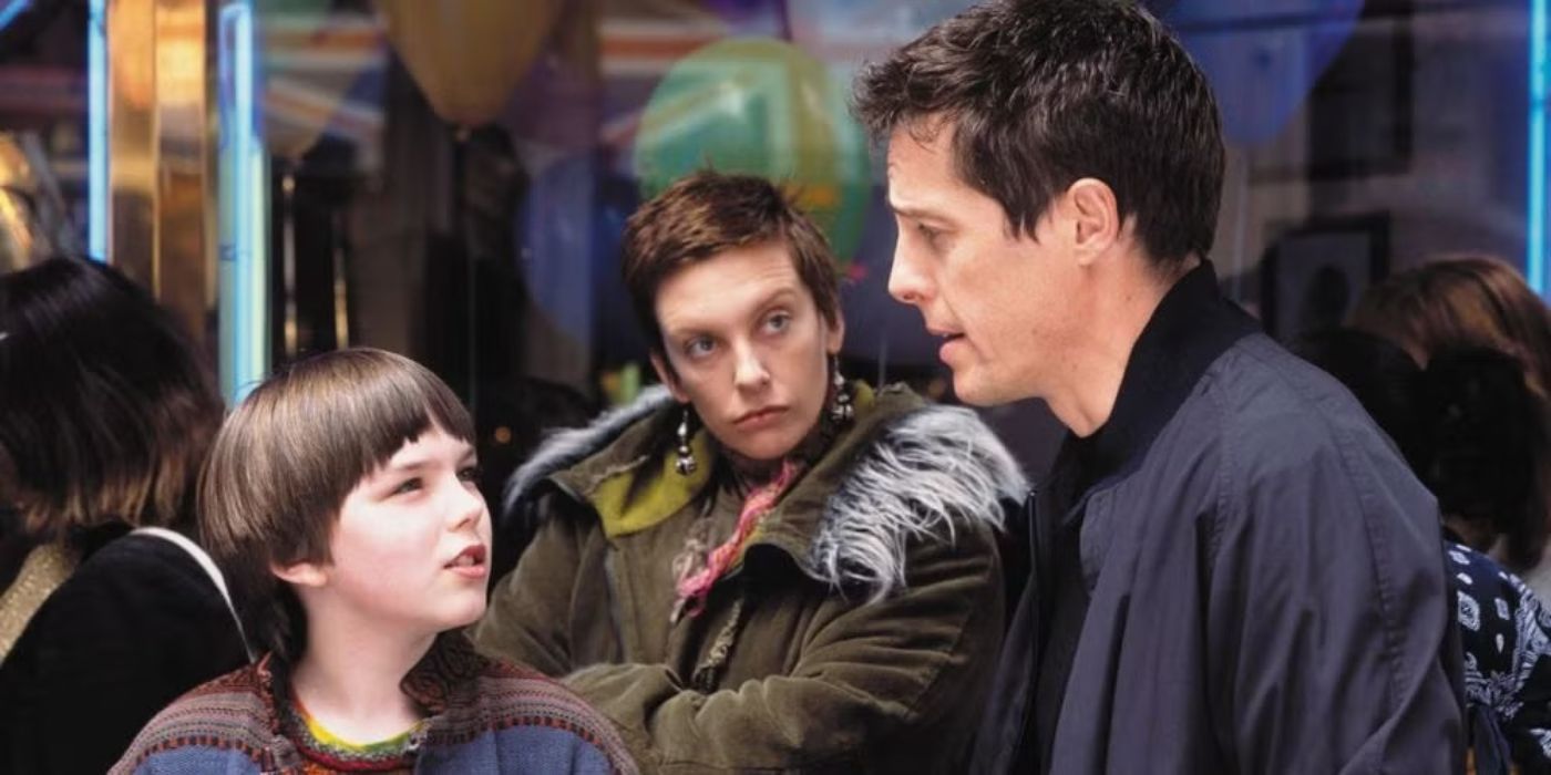 Nicholas Hoult as Marcus talks to Hugh Grant as Will as Toni Collette as Fiona looks suspicious in About A Boy