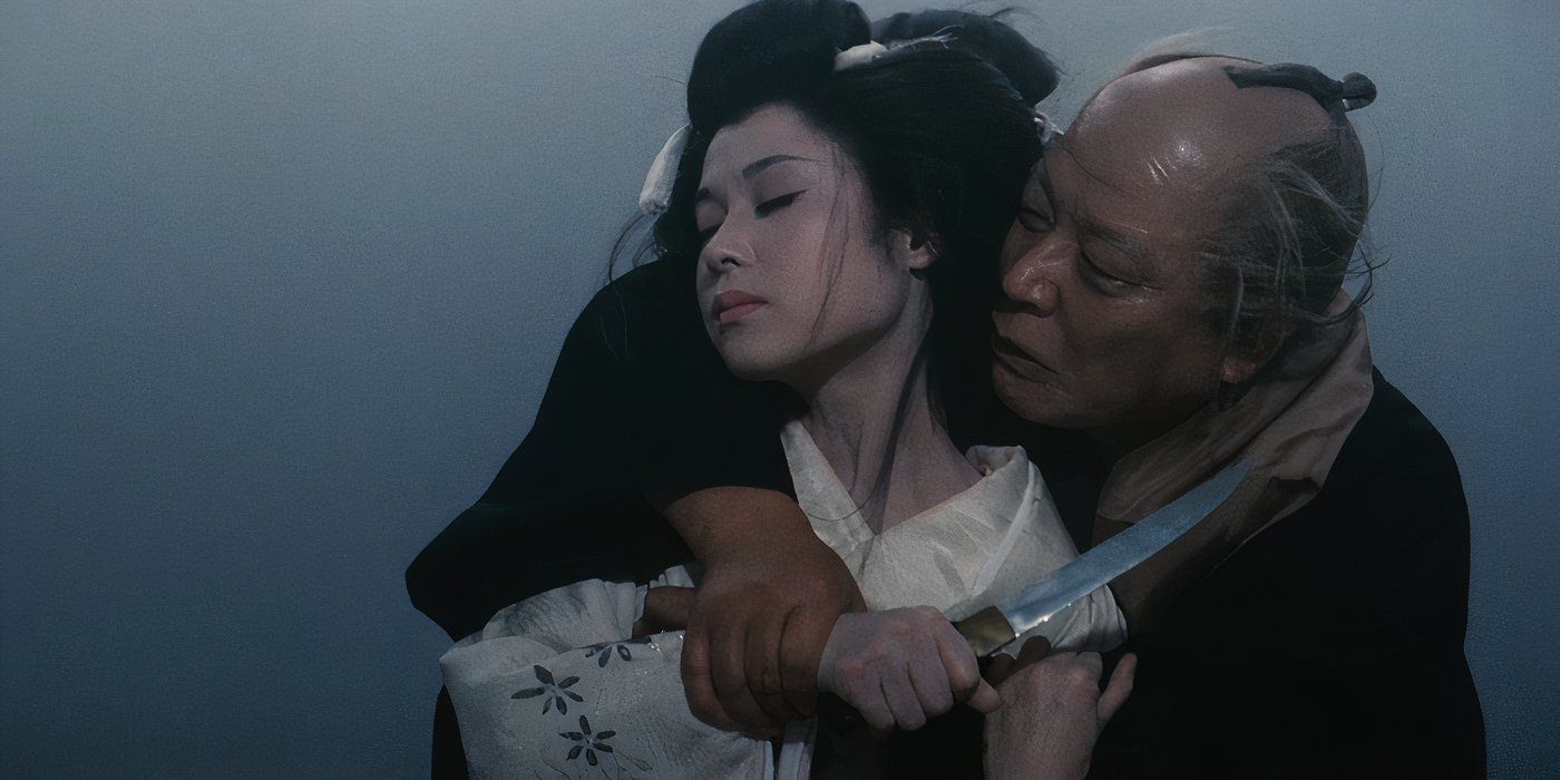 A man holding a knife and embracing a woman from behind in An Actor's Revenge