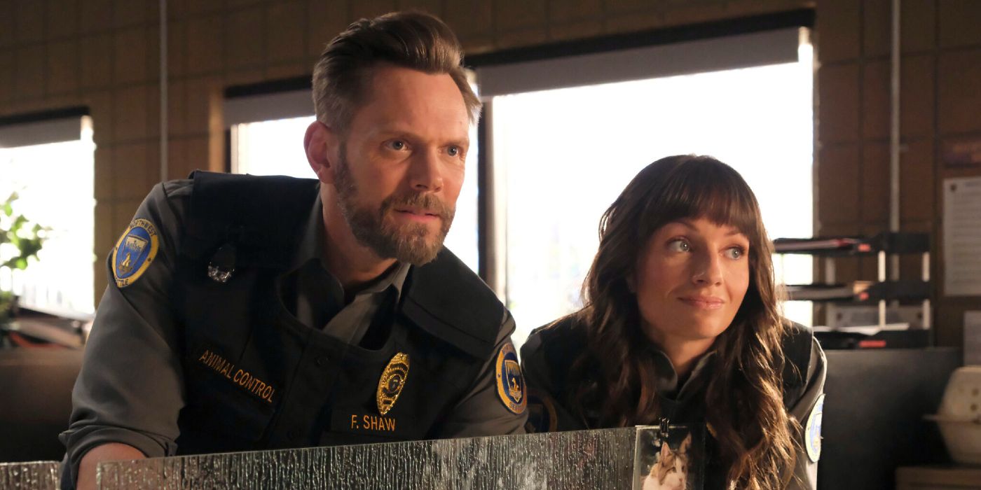 Joel McHale and Grace Palmer lean over a desk in Animal Control Season 3