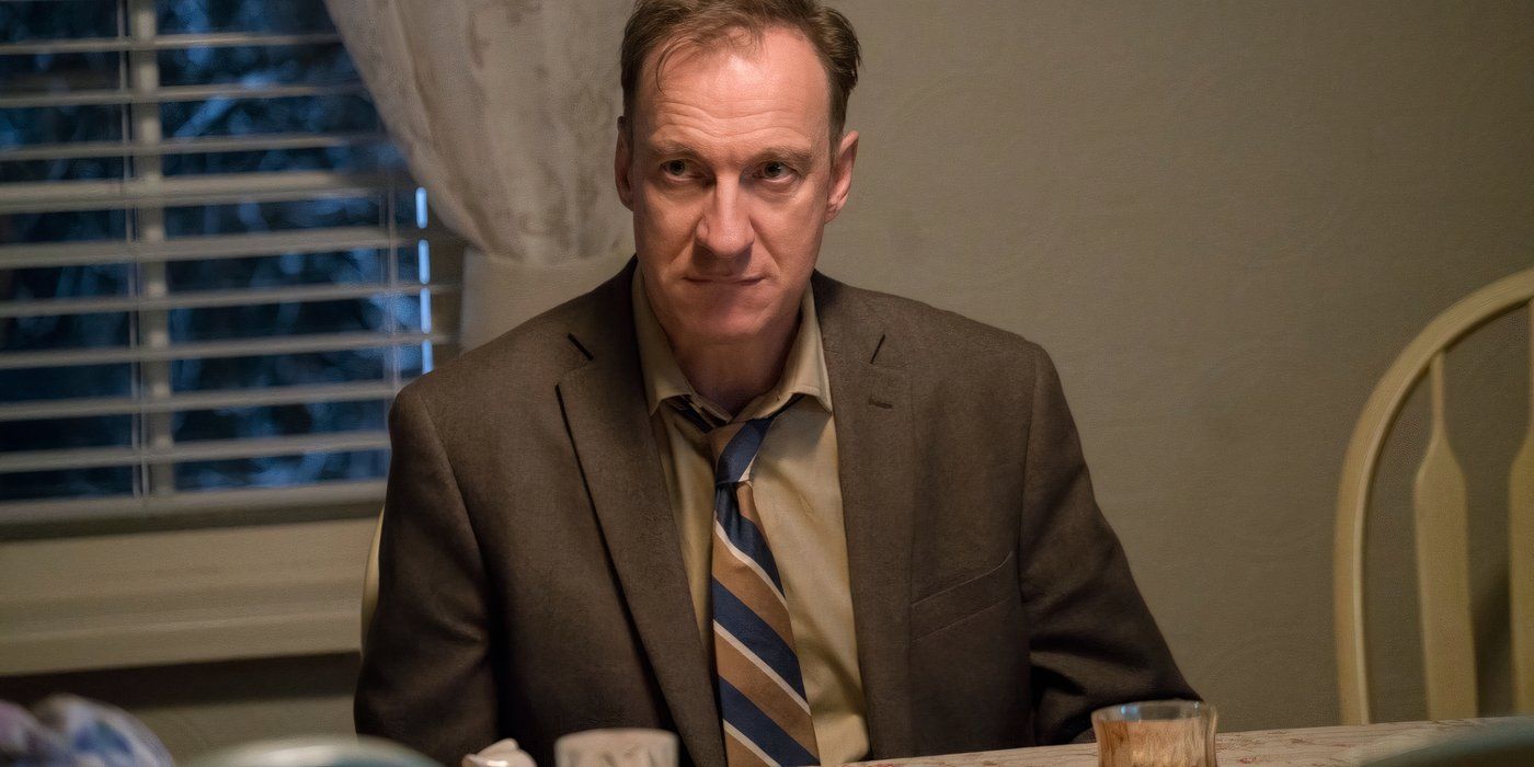 V.M. Varga sits at a table at night in Fargo season 3.