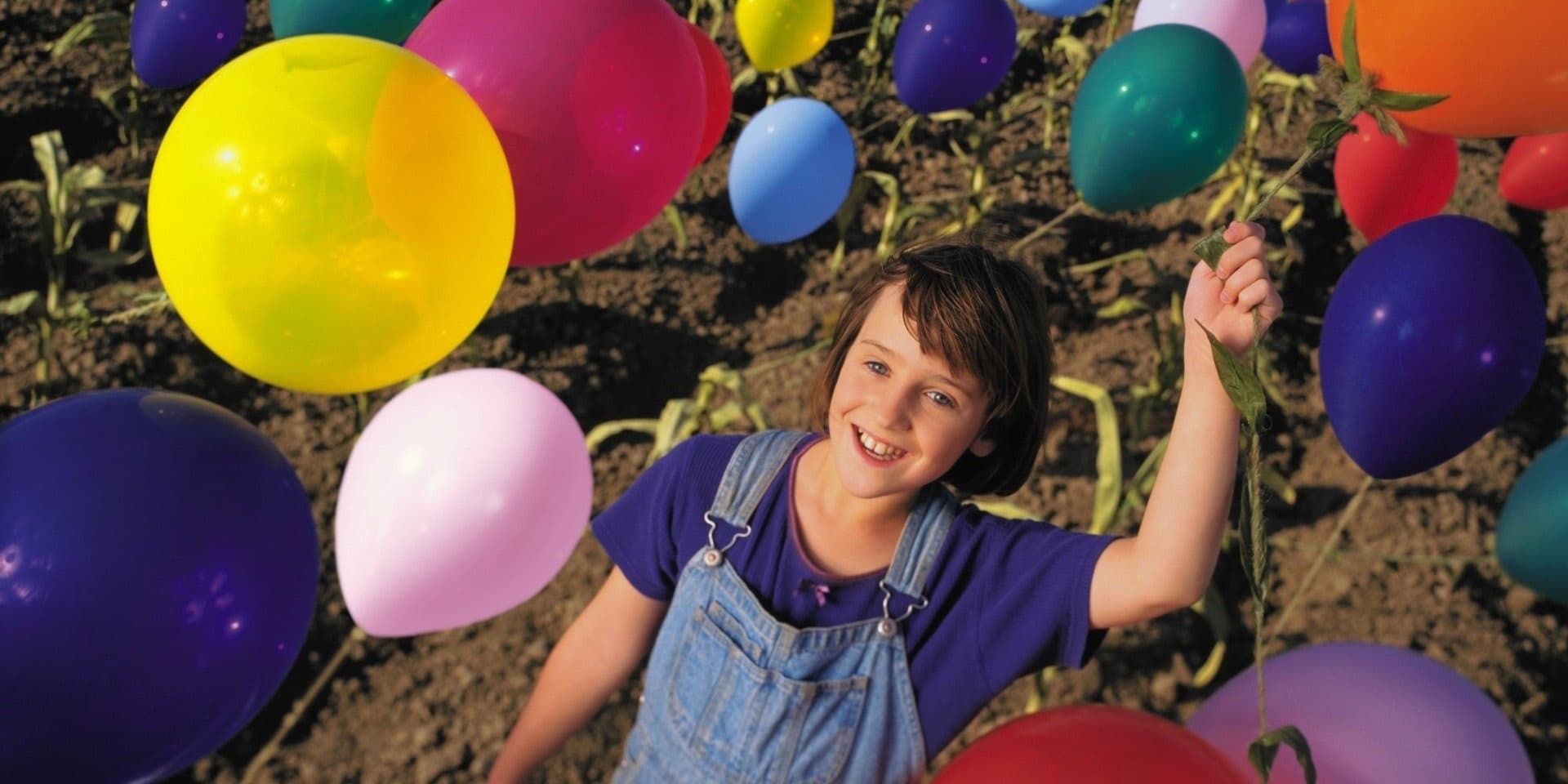 Mara Wilson as Willow Johnson in the middle of a farm crop full of balloons growing out of the ground in 'Balloon Farm' (1999)