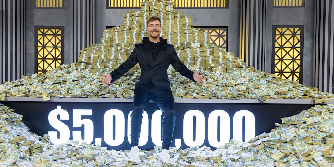 MrBeast sits atop a lit up sign for $5,000,000 amid a stack of cash on &lsquo;Beast Games&rsquo;