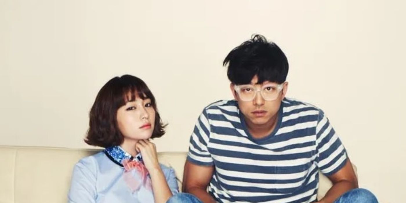 A man and woman sit on a couch in the K-drama Big, 2012.