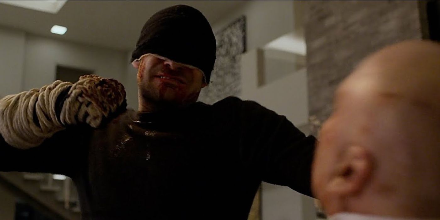 Daredevil with a bloody fist punching Kingpin in Daredevil