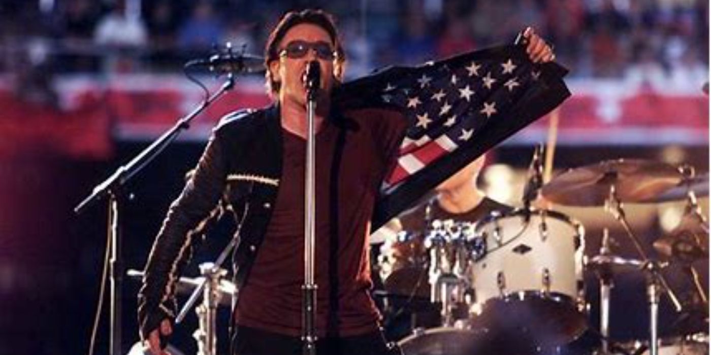 Bono from U2 wearing a jacket with an American flag at the 2002 Super Bowl