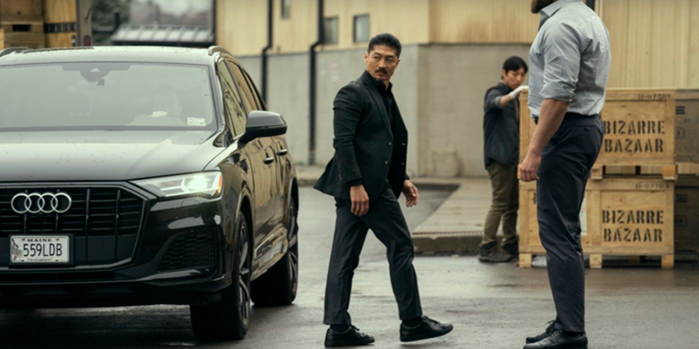 Brian Tee, walking out of the car in a black suit, as Francis Xavier Quinn in Reacher Season 3