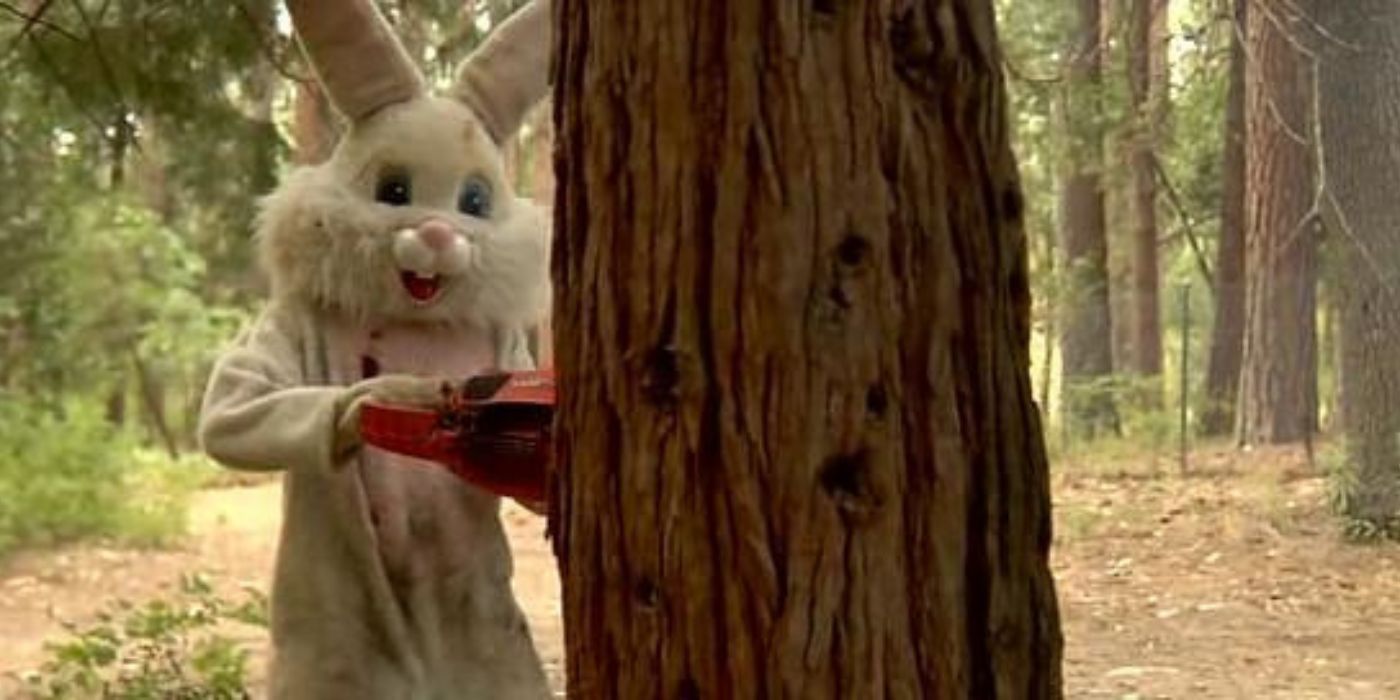 Bunnyman uses his chainsaw to cut down a tree in the woods in Bunnyman.