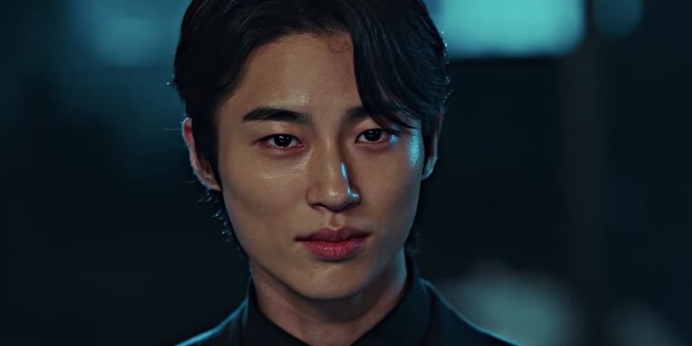 Byeon Woo-seok as Ryu Shi-oh in Strong Girl Nam-soon?in a black suit smiling at someone off-screen.