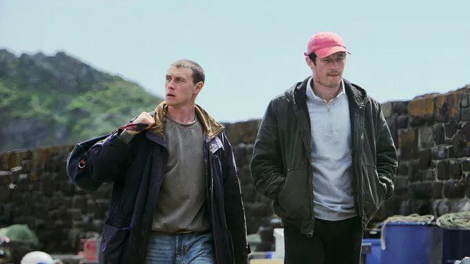 Callum Turner and George MacKay walking outside in Rose of Nevada