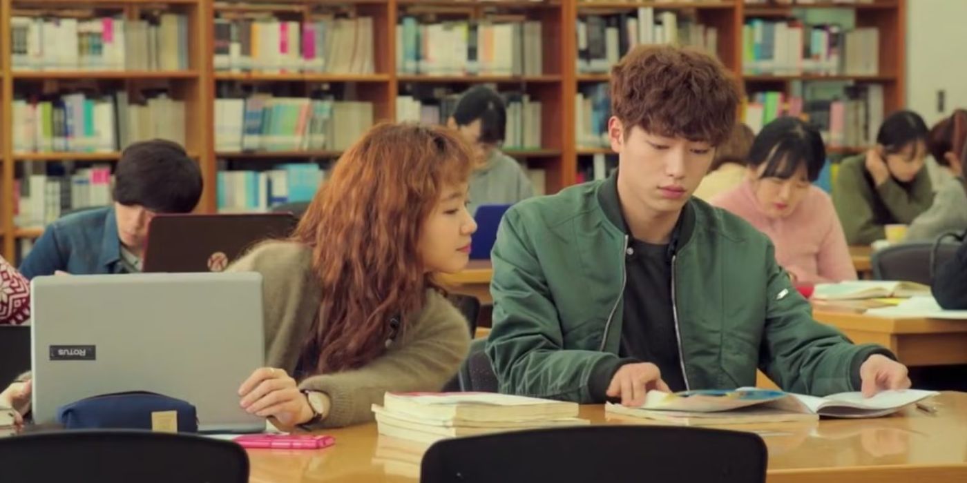 Two people read books in a library with others in Cheese in the Trap K-drama.