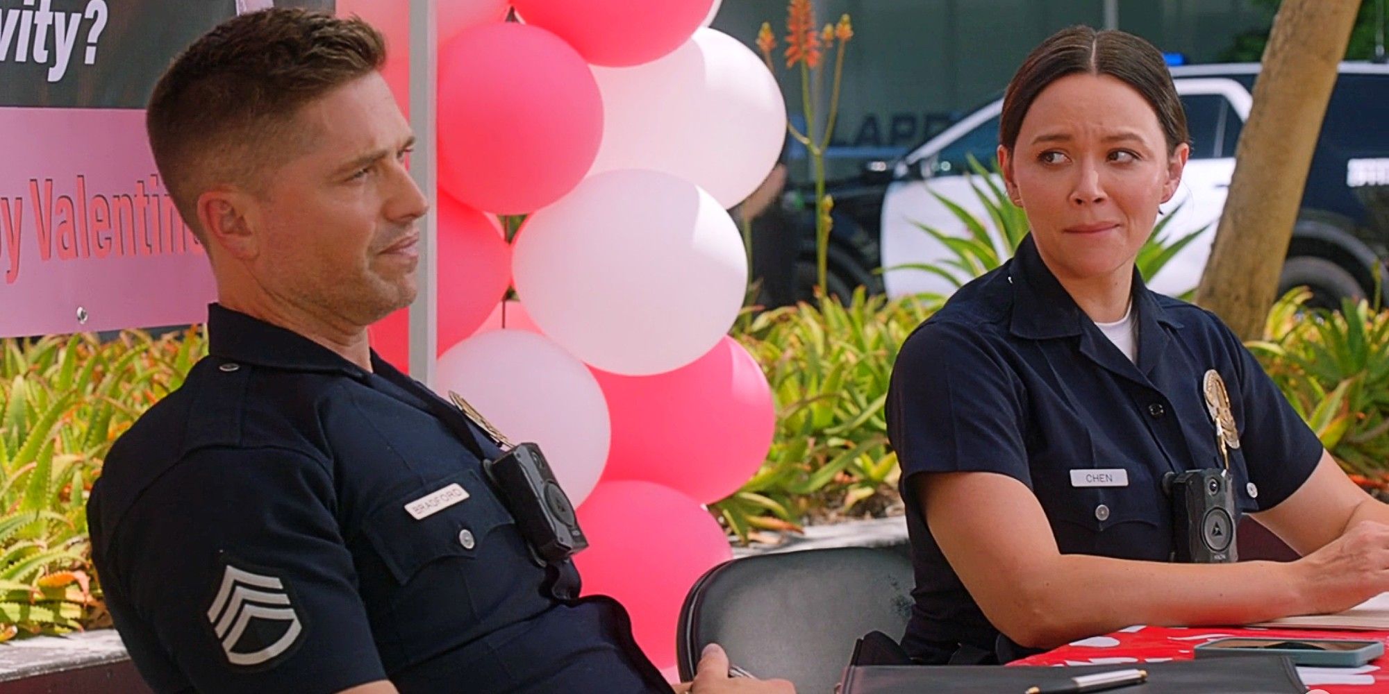 Tim Bradford and Lucy Chen (Chenford) sitting at a Valentine&rsquo;s Day booth together in The Rookie Season 7