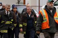 The cast wear first responder uniforms and walk through a scrapyard in Chicago Fire episode Relief Cut.