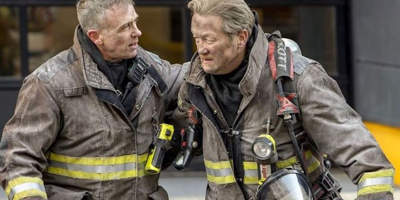 Christopher Herrmann (David Eigenberg) and Mouch (Christian Stolte) in fire gear, grimy, in Chicago Fire