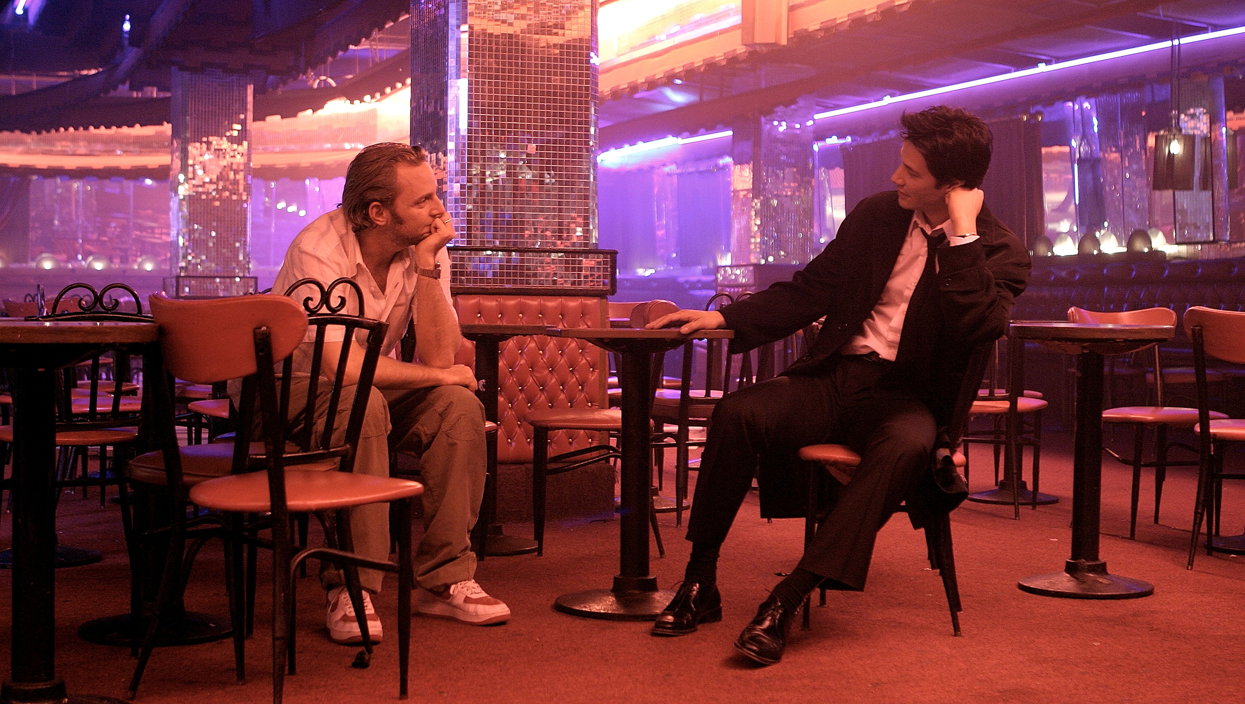 Keanu Reeves and Francis Lawrence sit in a bar on the set of Constantine