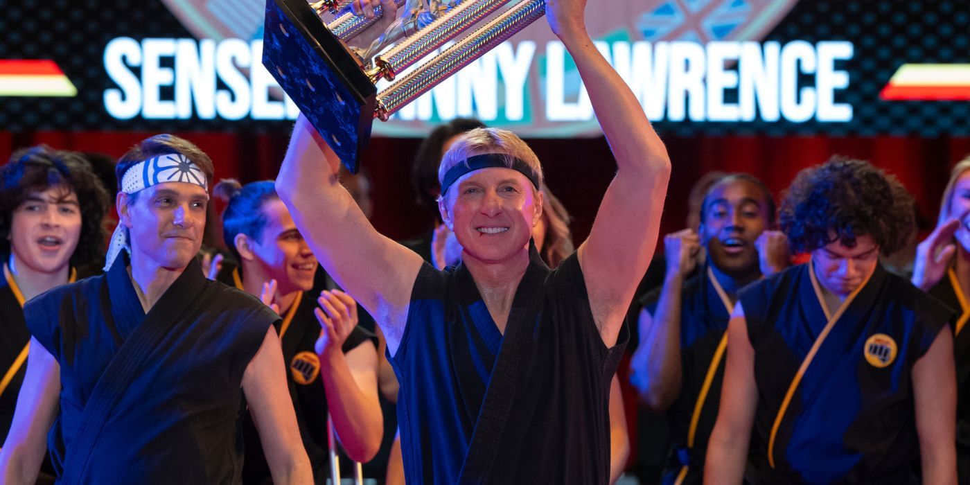 William Zabka holding up a trophy as Johnny Lawrence in the Cobra Kai finale.