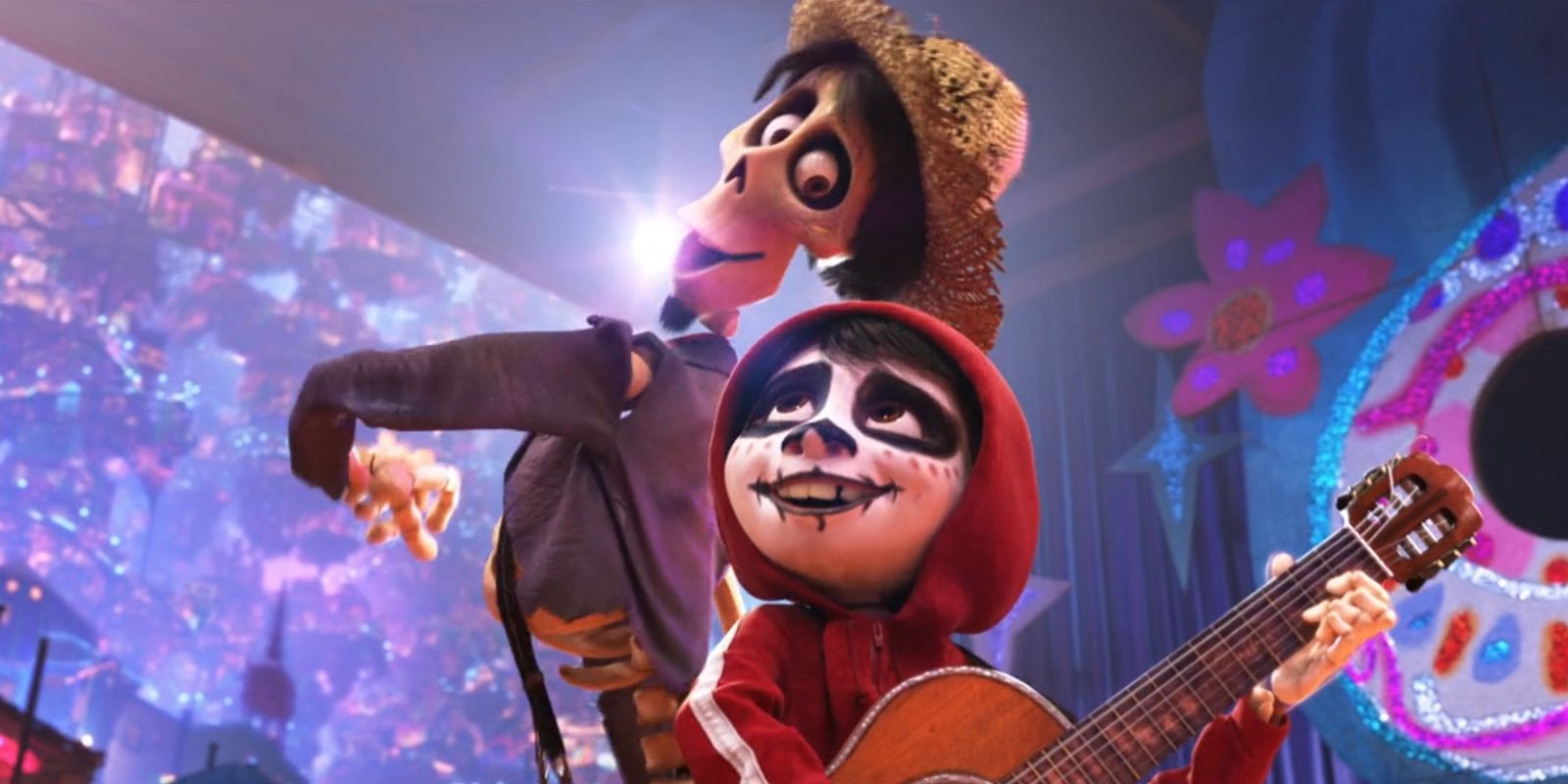 Miguel (Anthony Gonzalez) plays the guitar while Héctor (Gael García Bernal) dances behind him in 'Coco'.