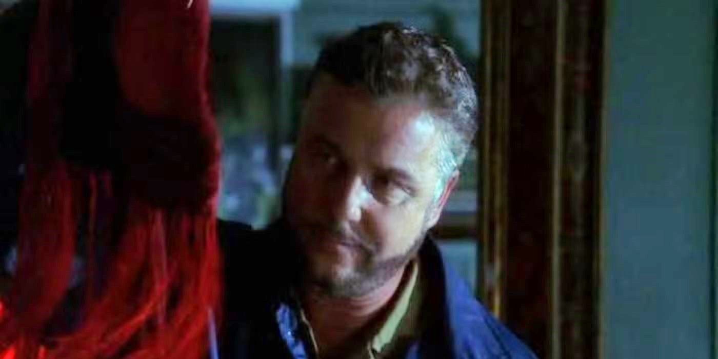 An agent looks at a red, fringed object in CSI episode Butterfield.