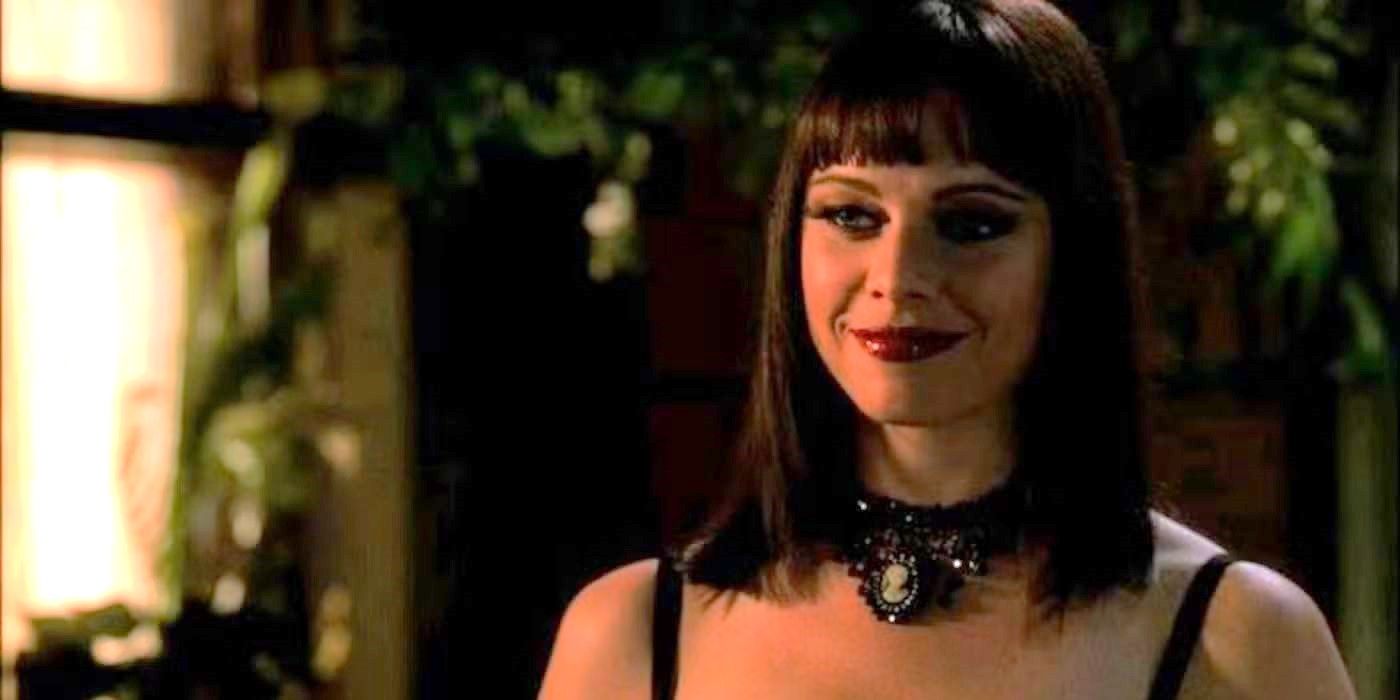 A woman with dark hair and dark red lipstick smiles in CSI episode Slaves of Las Vegas.