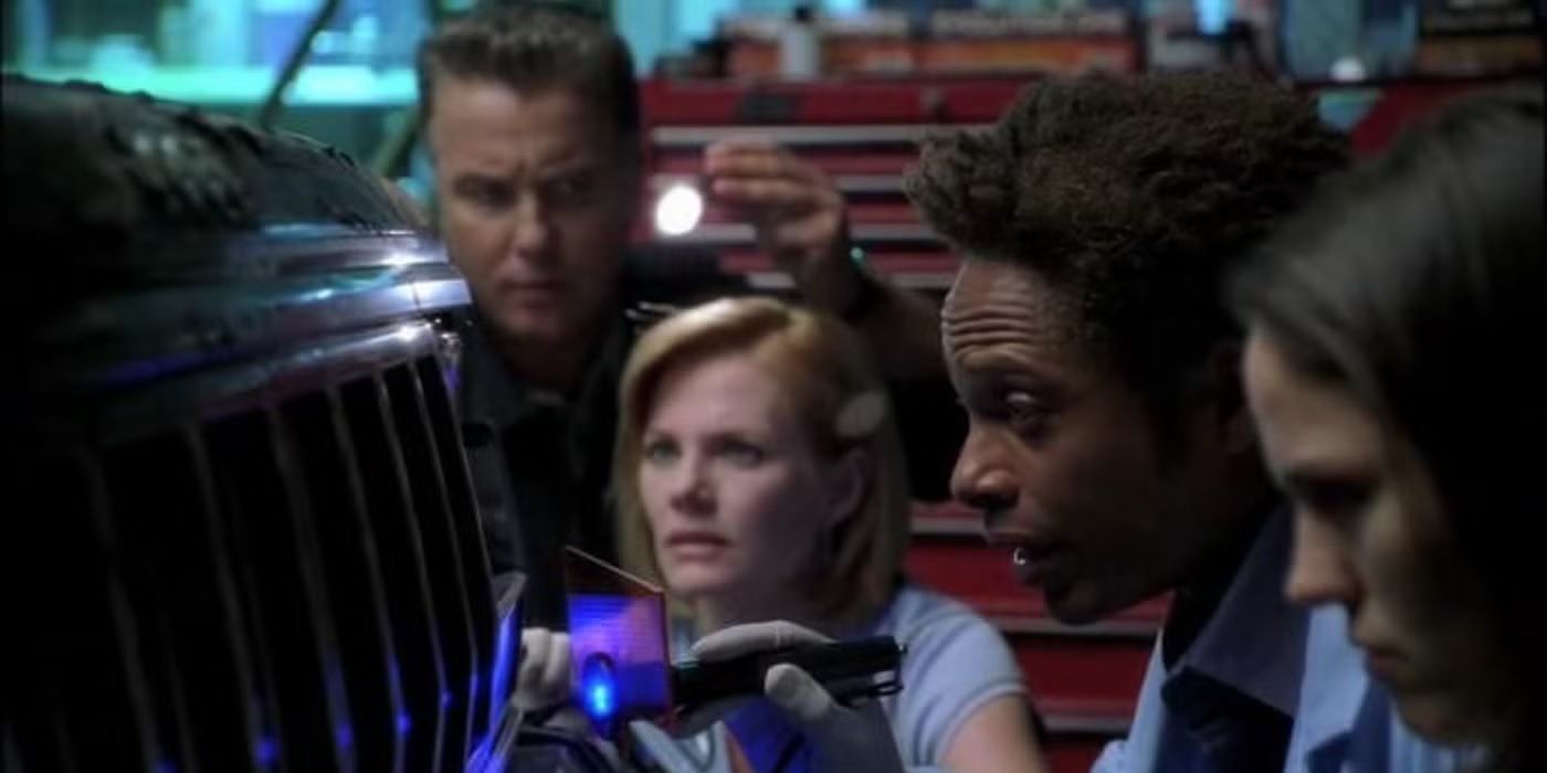 The CSI agents inspect the front of a vehicle and hold flashlights in CSI episode Chaos Theory.