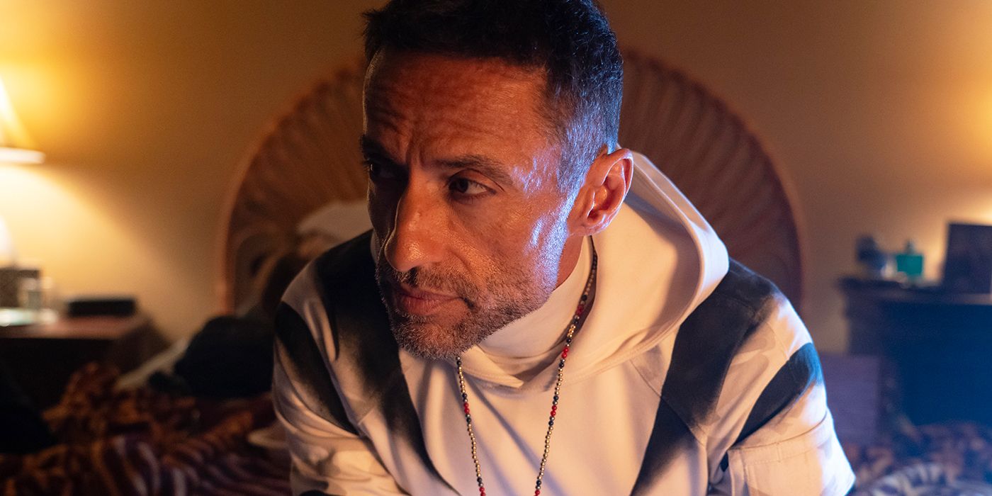 Kamar de los Reyes as Hector Ayala in his White Tiger costume sitting on his bed in Daredevil: Born Again.