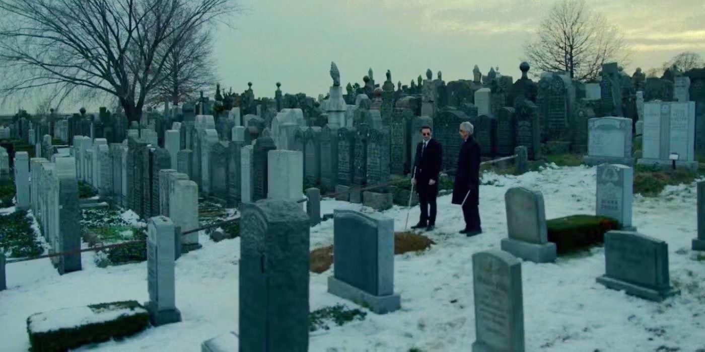 Matt Murdock and Stick standing in a graveyard in winter in Daredevil Season 2, Episode 13.