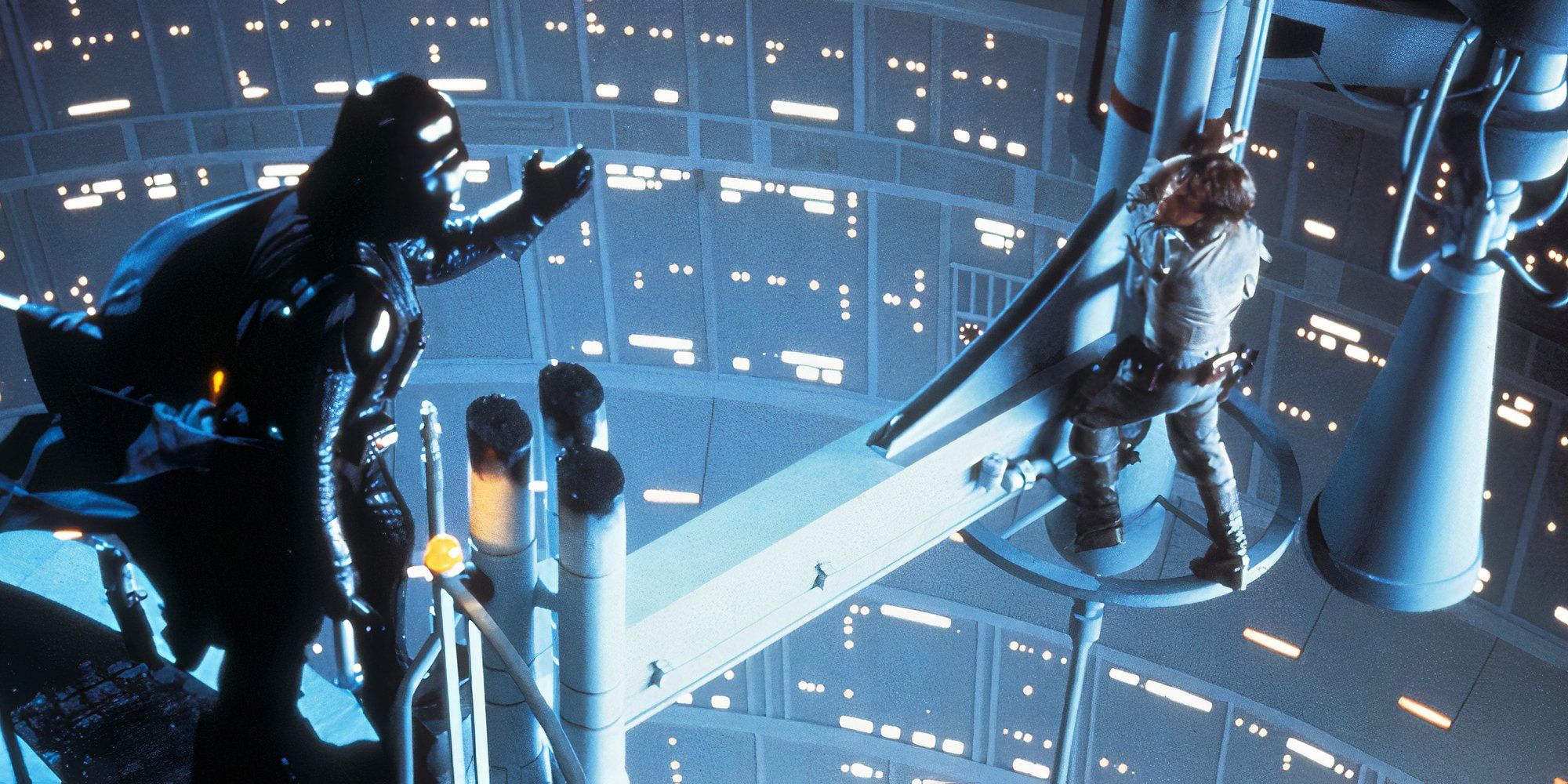 Darth Vader reaches to Luke who is standing on a high platform in Star Wars: The Empire Strikes Back.