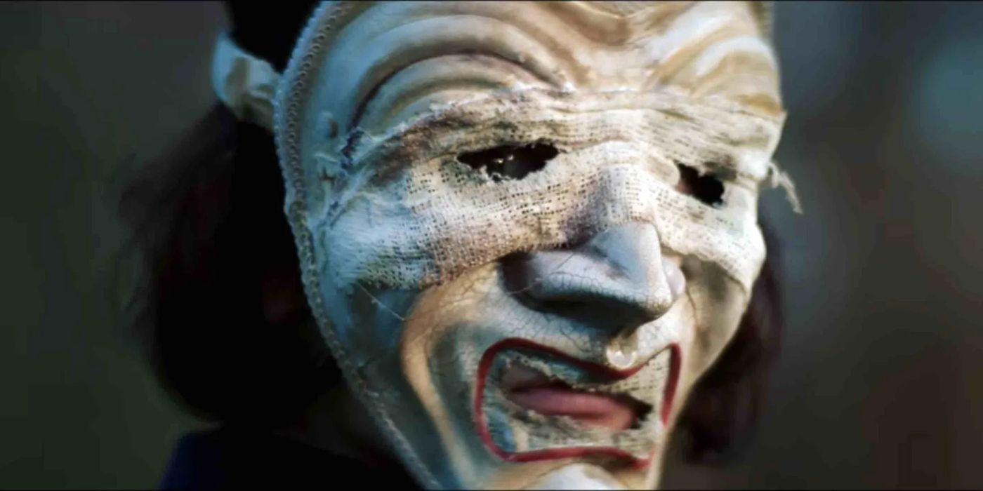 Tragedy (Chiara D&rsquo;Anna) wearing a white mask in Everyone Is Going to Die