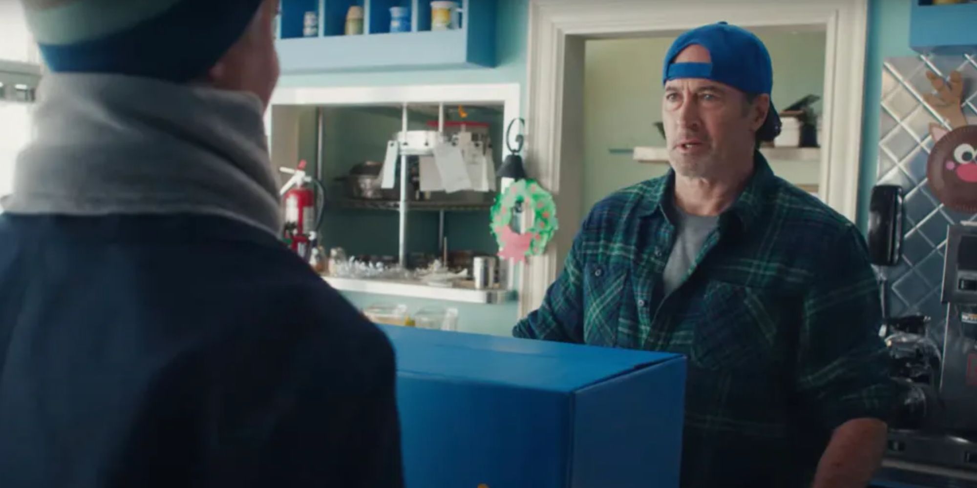 Scott Patterson as Luke accepting a package in the Gilmore Girls Walmart ad