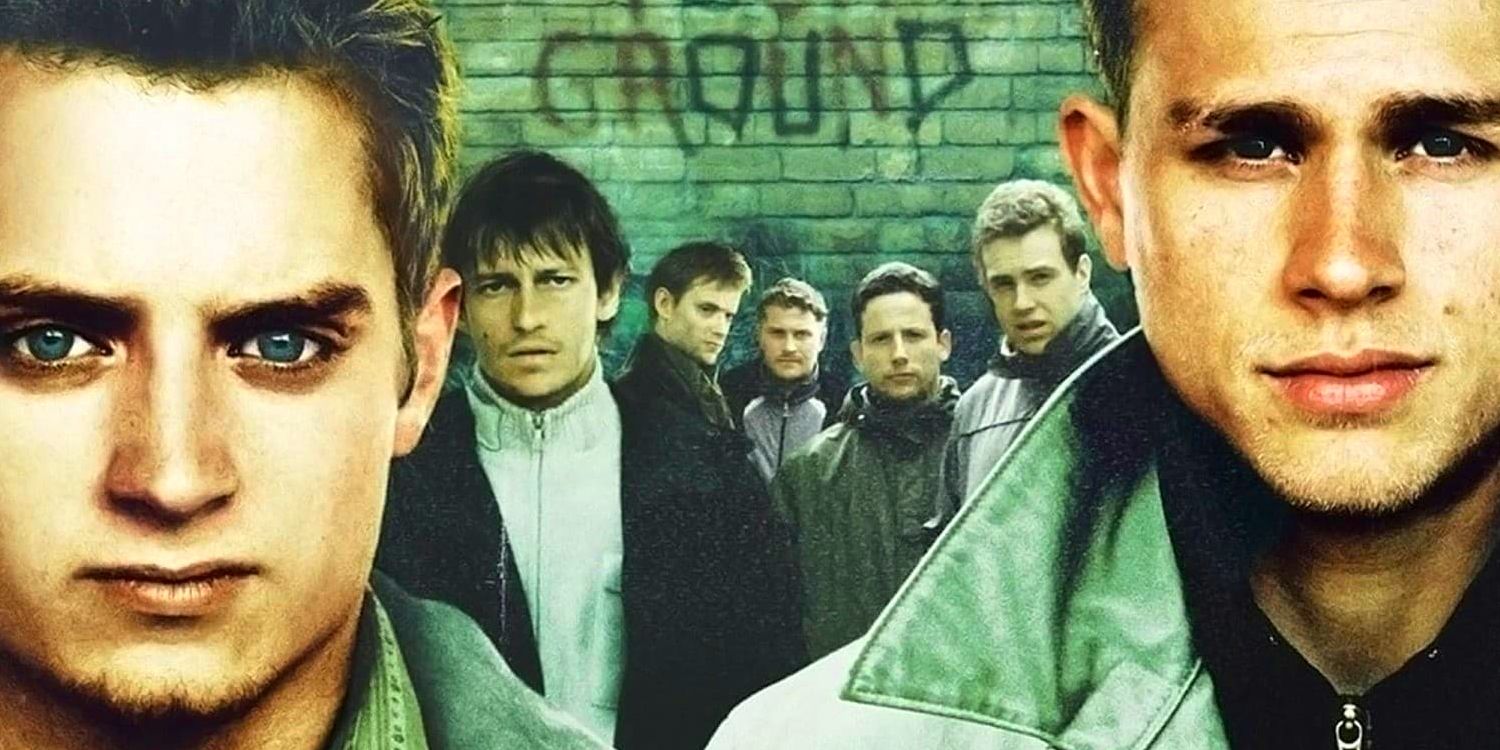 Matt and Pete, played by actors Elijah Wood and Charlie Hunnam, look ahead while five rough-looking young men stand behind them in Green Street Hooligans.