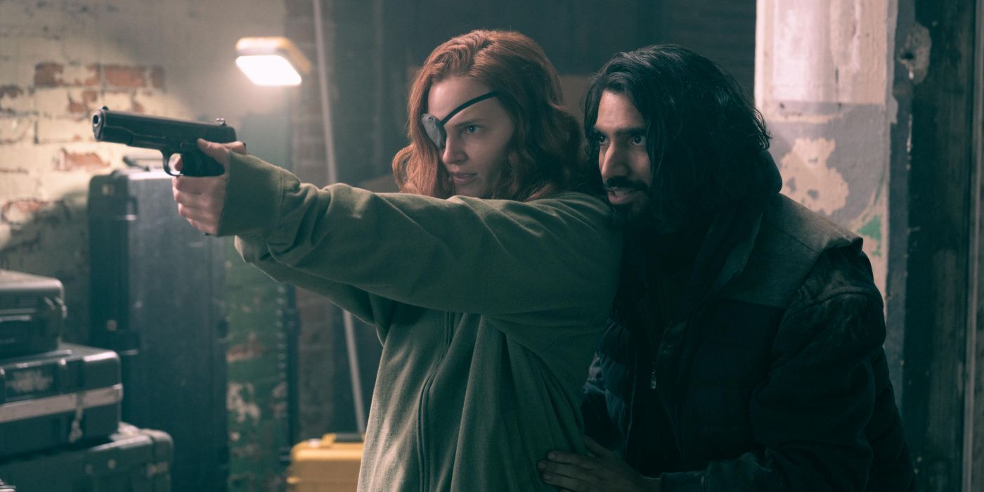 Omar Maskati as Steve holding a gun with Janine in The Handmaid&rsquo;s tale.