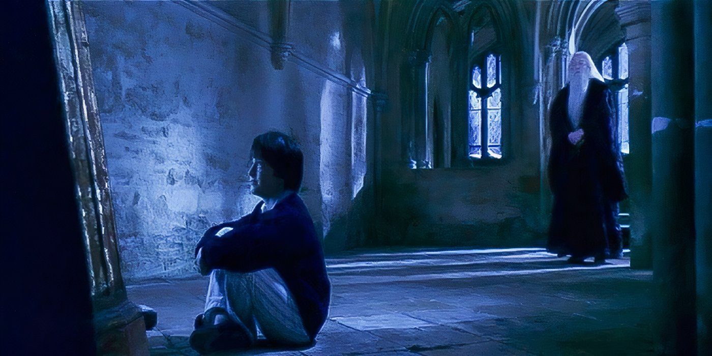 Harry Potter (Daniel Radcliffe) sits in front of the Mirror of Erised as Dumbledore (Richard Harris) watches