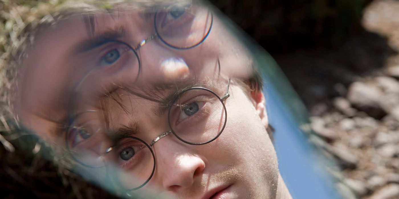 Harry looks at his reflection in a piece of mirror in &lsquo;Harry Potter and the Deathly Hallows: Part 1&rsquo;