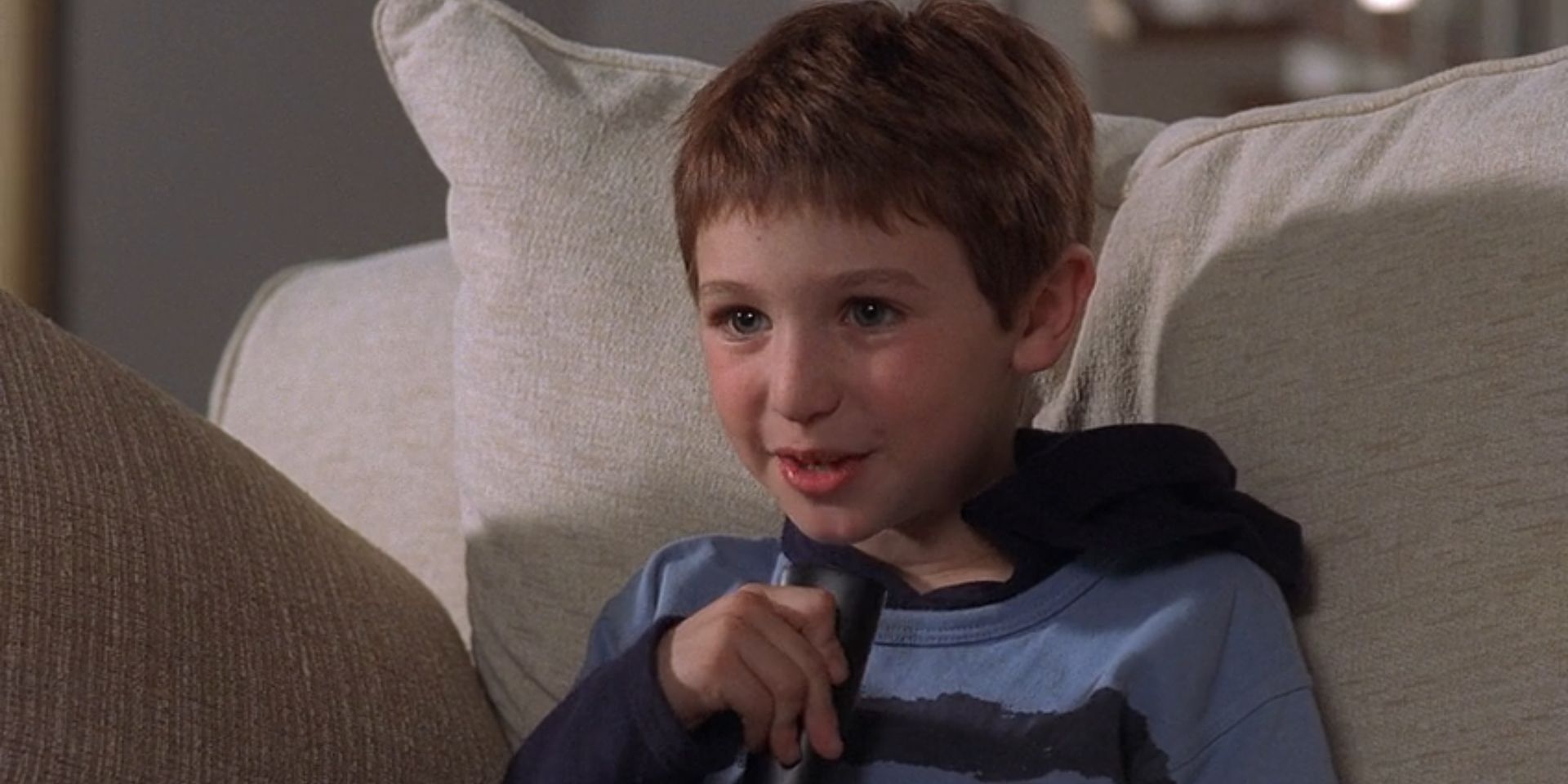 Kevin McCallister, played by Mike Weinberg, speaks into a remote in 'Home Alone 4'.