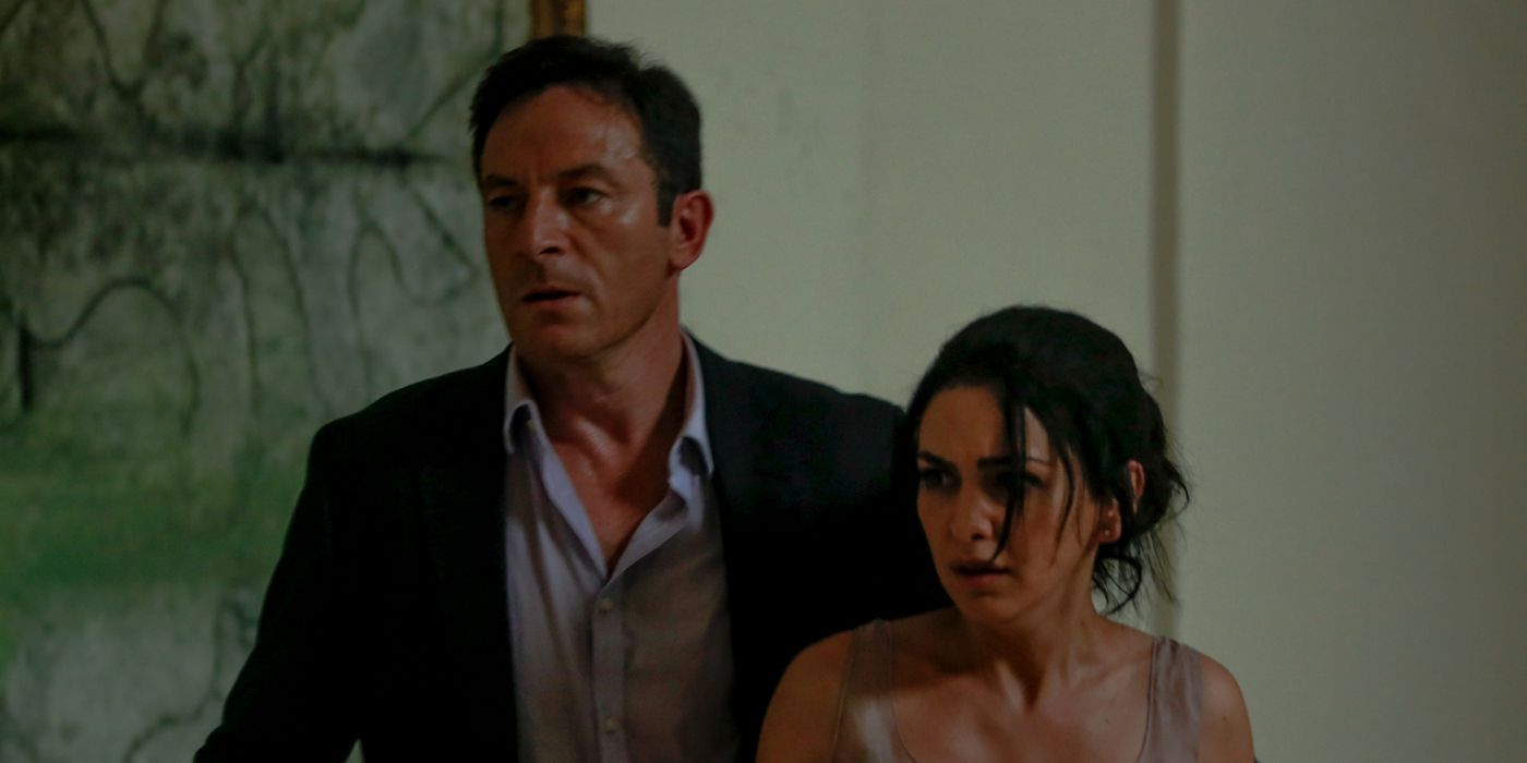 Nazanin Boniadi as Zahra and Jason Isaacs as Vasili looking scared in Hotel Mumbai.