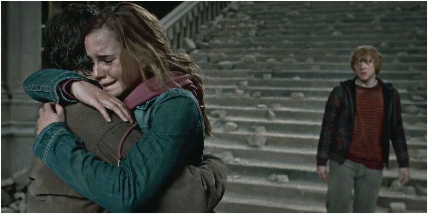 Hermione (Emma Watson) hugs Harry (Daniel Radcliffe) as Ron (Rupert Grint) watches in 'Harry Potter and the Deathly Hallows Part 2'