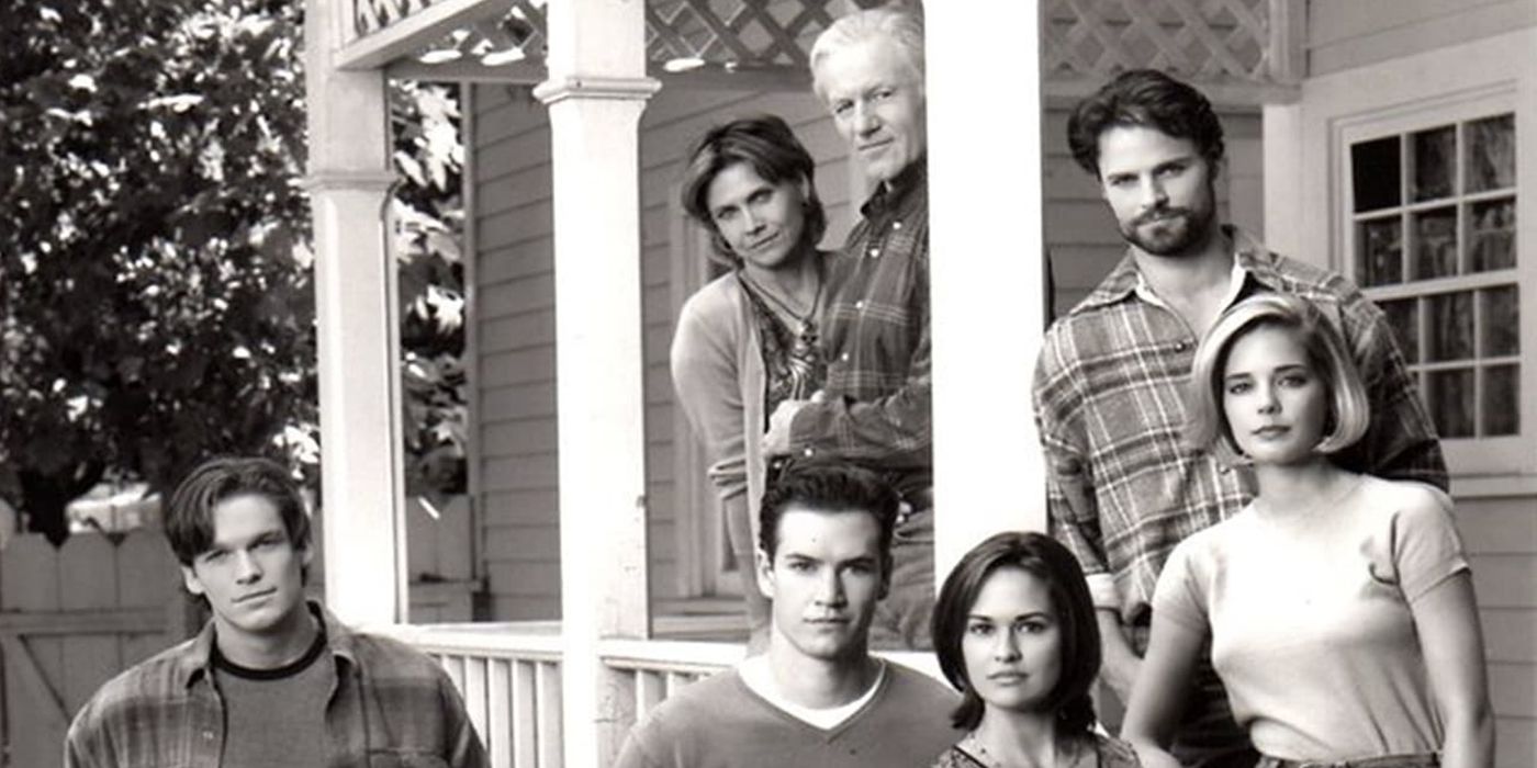 A black and white image of the cast of Hyperion Bay posing on the porch of a suburban home.