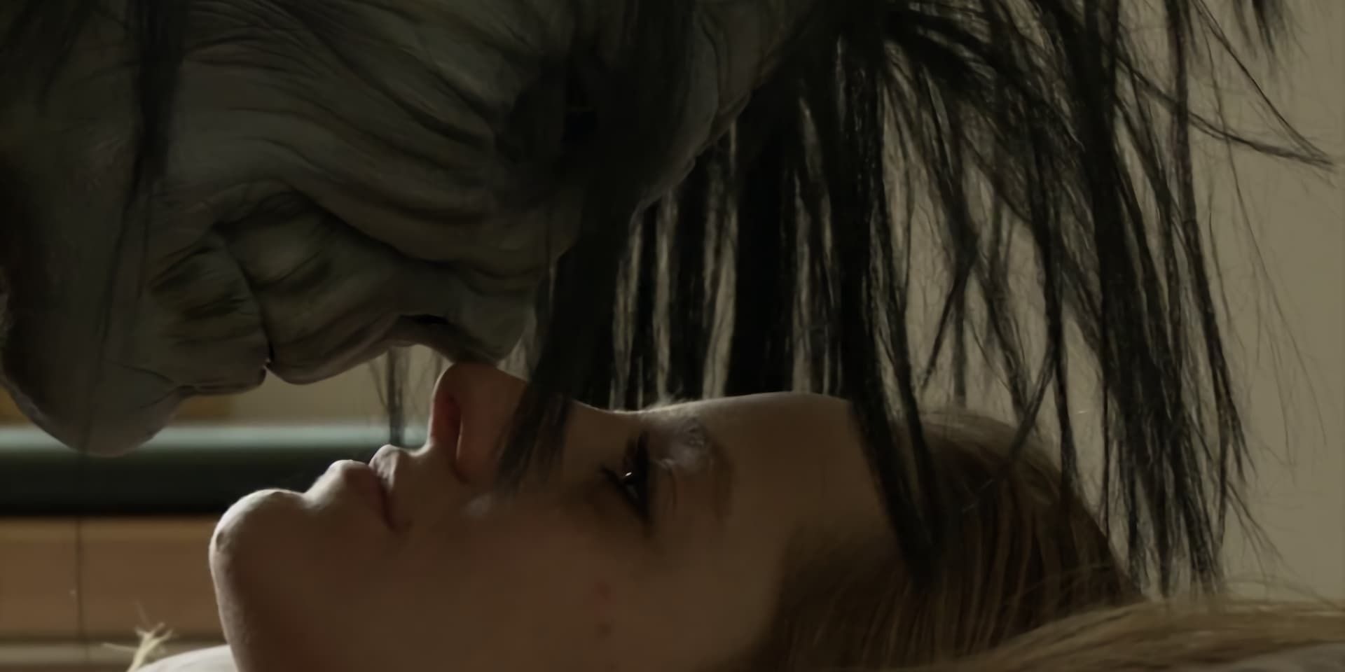 An alien creature with grey skin and long black hair about to kiss a woman laying on her back in Neil Breen&rsquo;s &lsquo;I Am Here&hellip;.Now&rsquo;