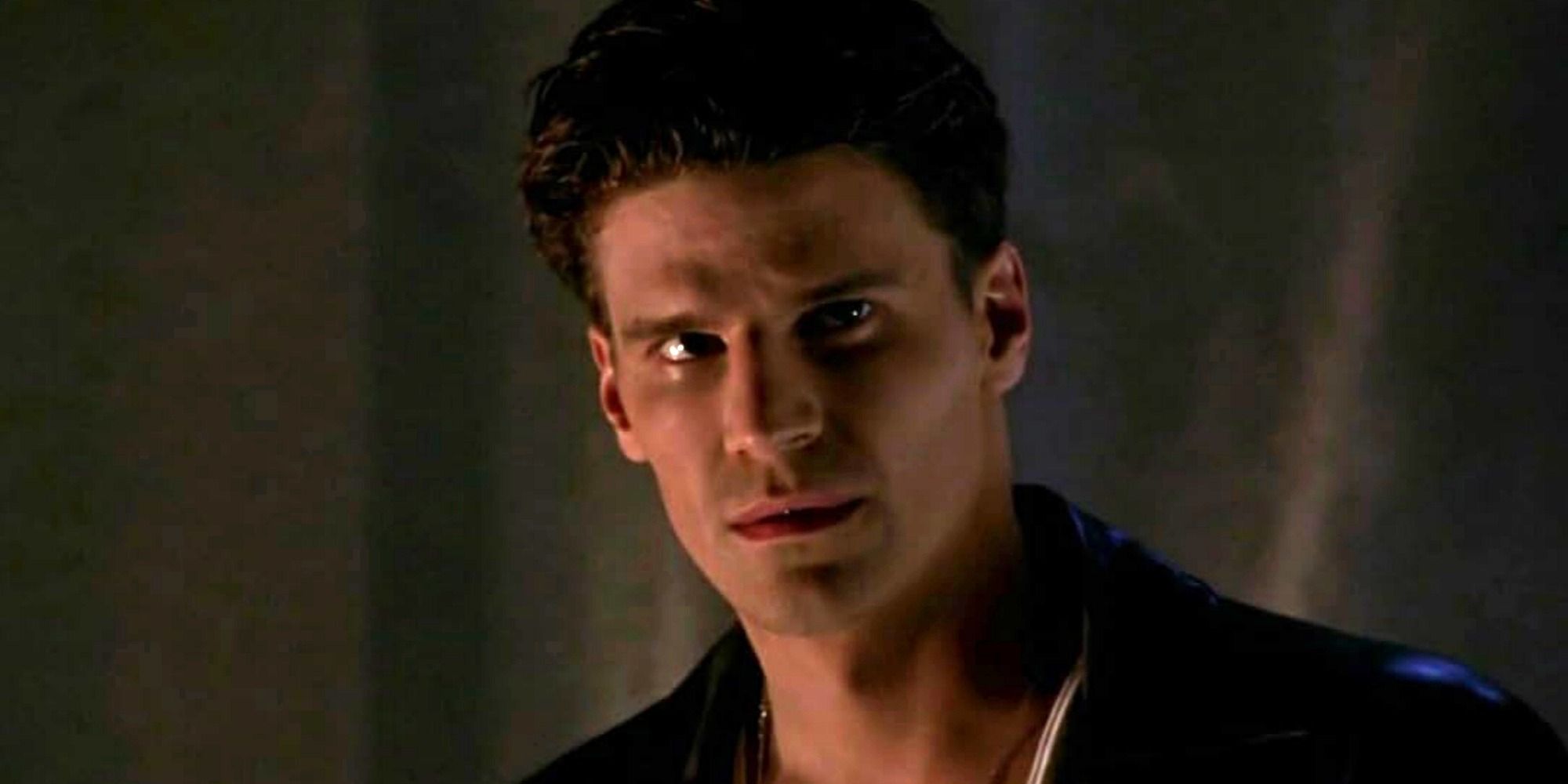 David Boreanaz as Angel solemnly looks to someone off-screen in Buffy the Vampire Slayer.