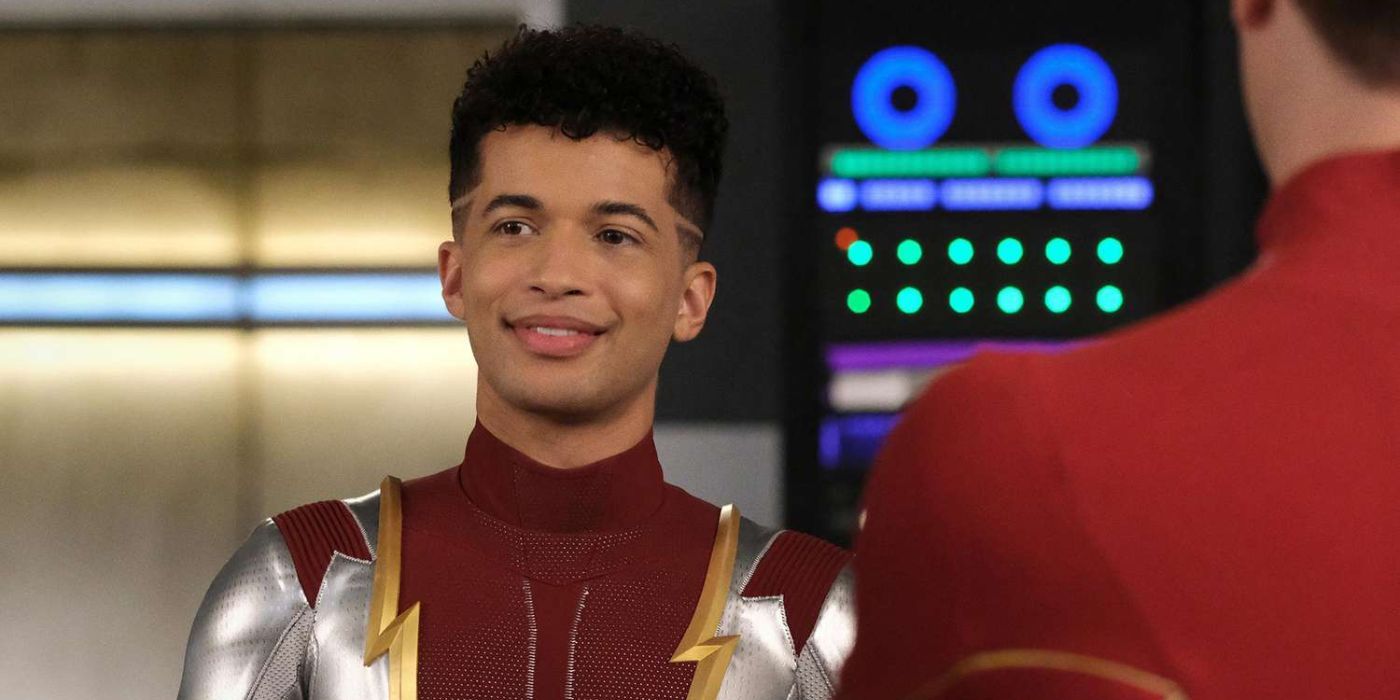 Jordan Fisher as Impulse in a superhero suit, smiling on The Flash.