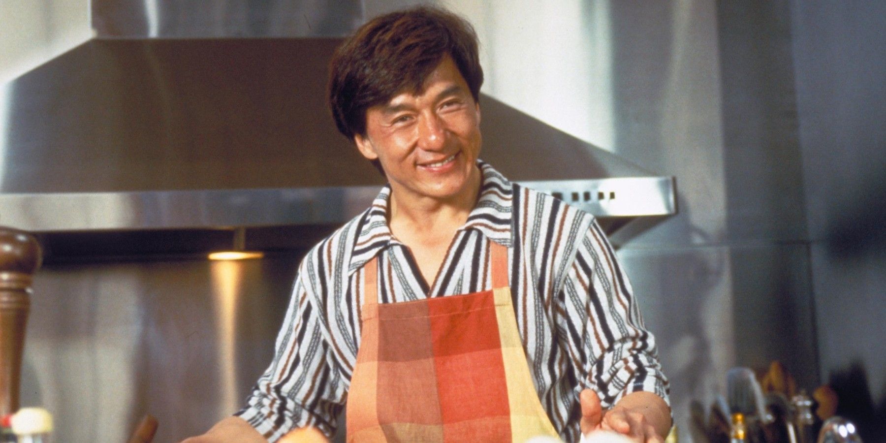 Jackie Chan smiling in a kitchen in Mr. Nice Guy