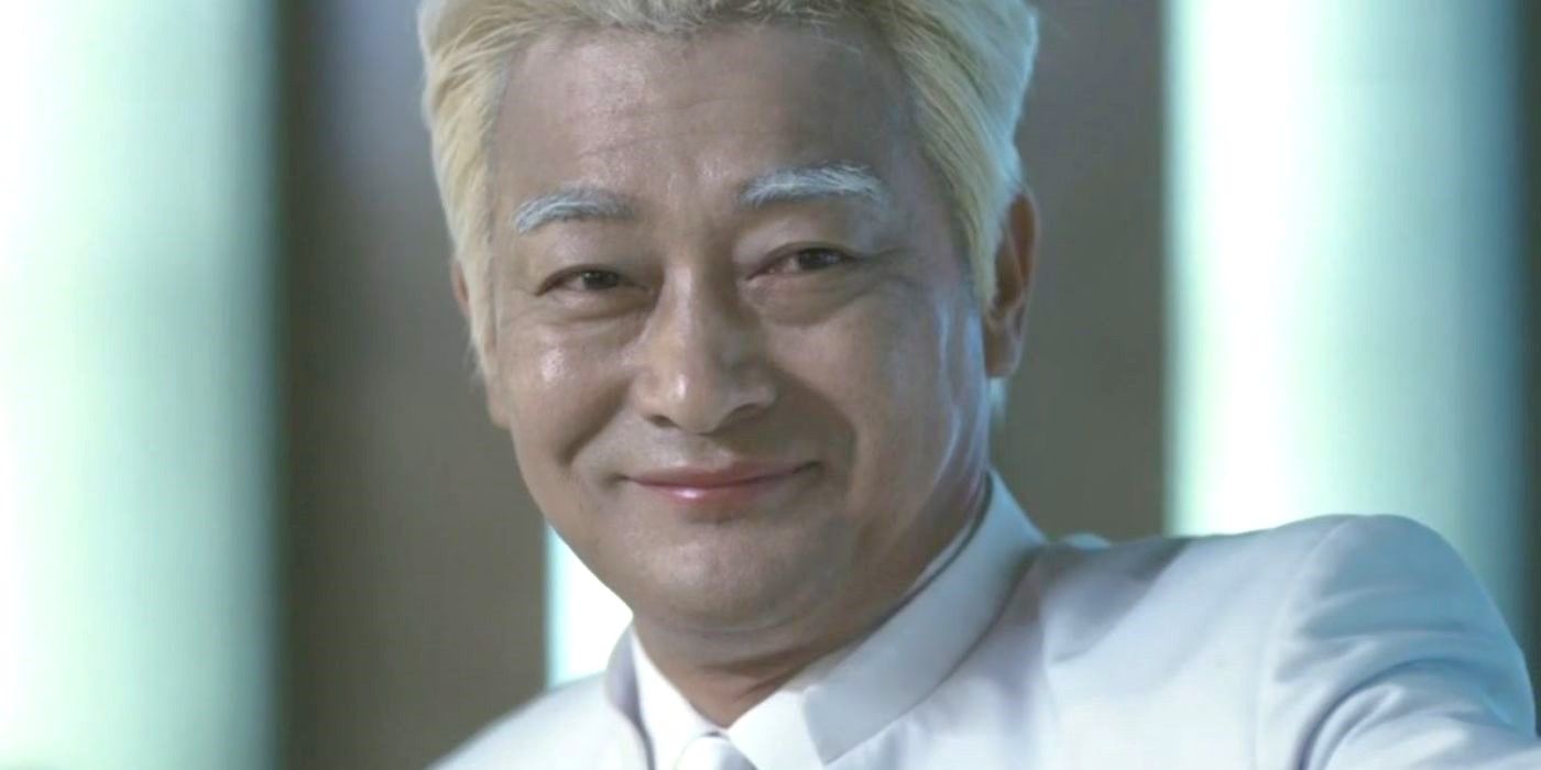 Jo Sung-ha in a white suit smiles and looks at someone off-screen in Save Me.