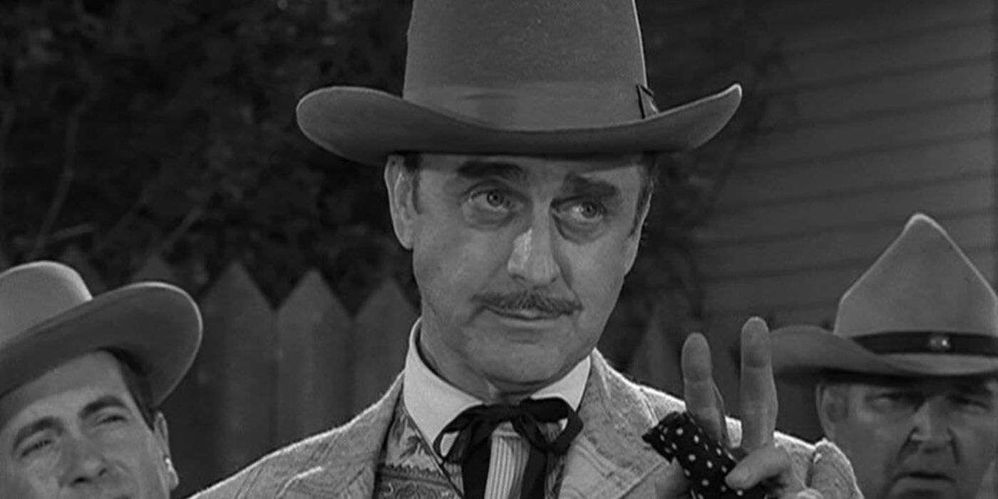 John Dehner in an Old West outfit waves at someone off-screen with a handkerchief in The Twilight Zone.
