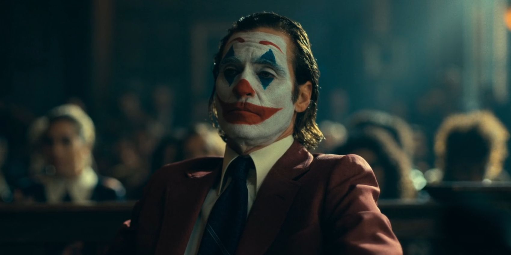 Arthur Fleck, played by Joaquin Phoenix, wears full Joker makeup while in court in 'Joker: Folie à Deux'.