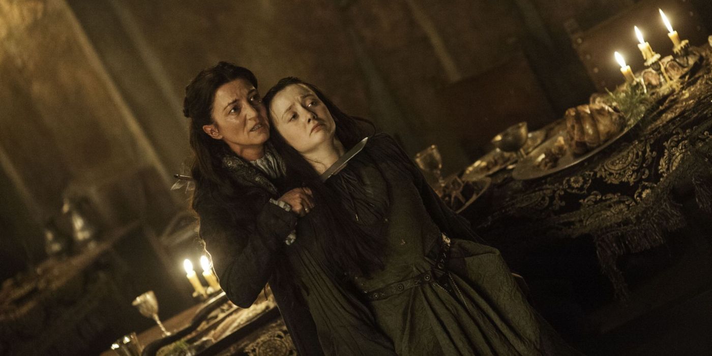 Michelle Fairley as Catelyn Stark holds a dagger to Joyeuse Frey's (Kelly Long) throat in "Game of Thrones' 