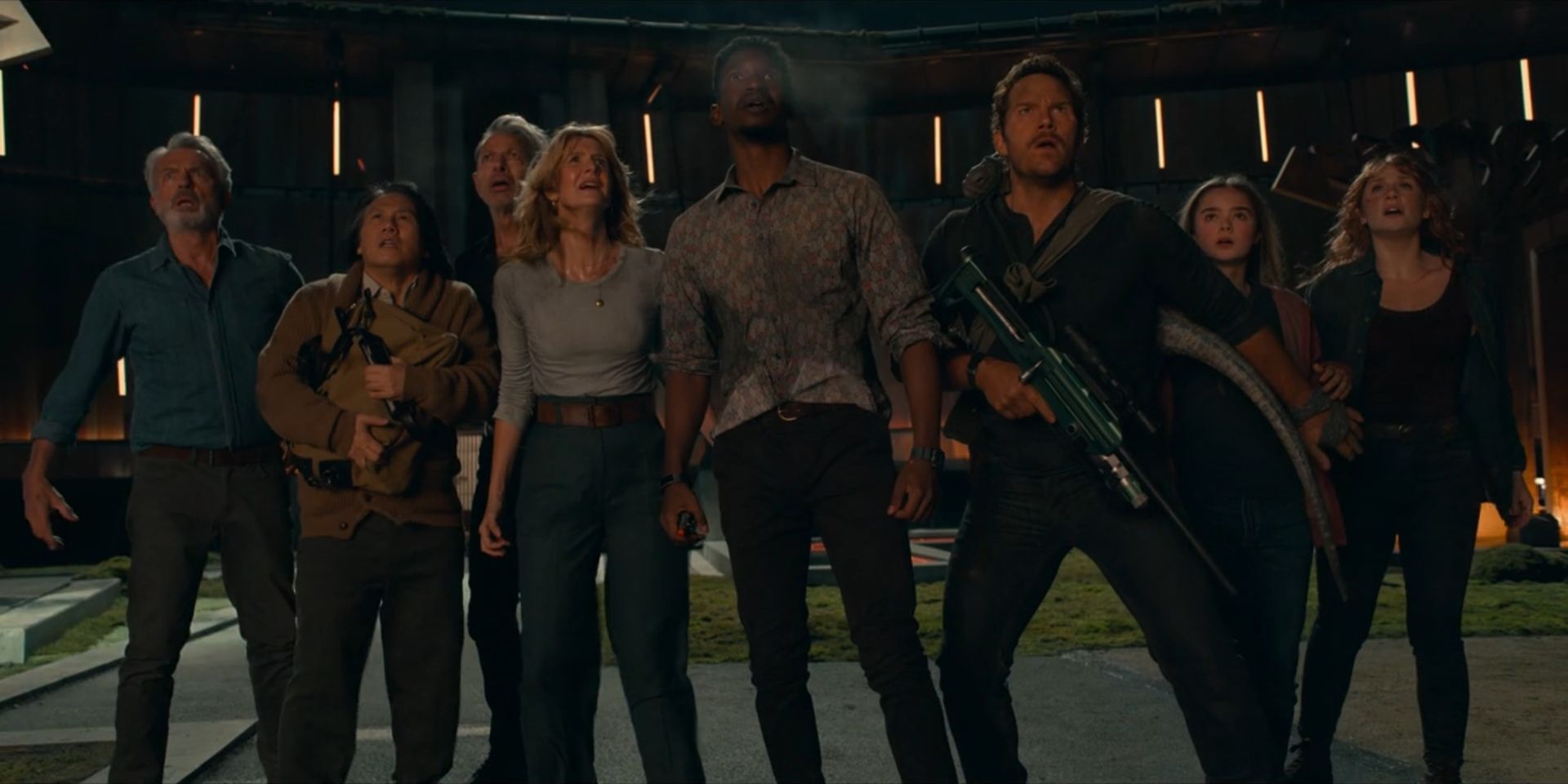 The main cast of 'Jurassic World Dominion' looks concerned while looking up.