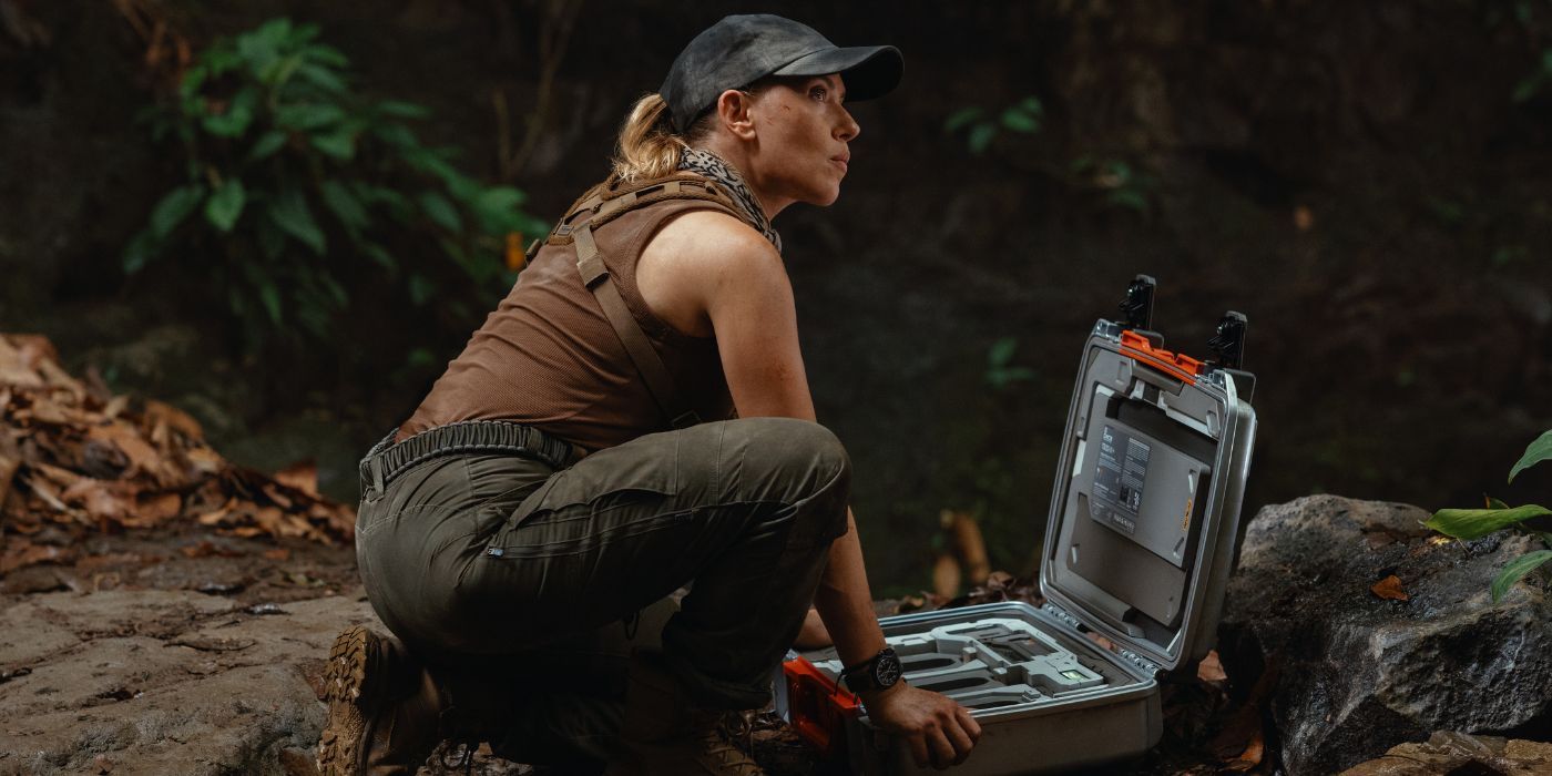 Scarlett Johansson as Dr. Zora Bennett setting up a briefcase in Jurassic World Rebirth.