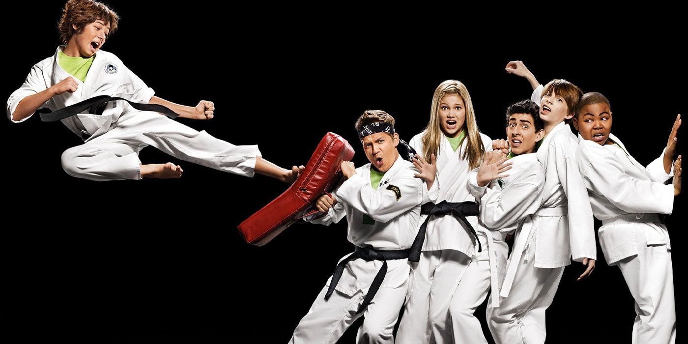 One person kicks in midair as the others group together in martial arts uniforms in Kickin' It.