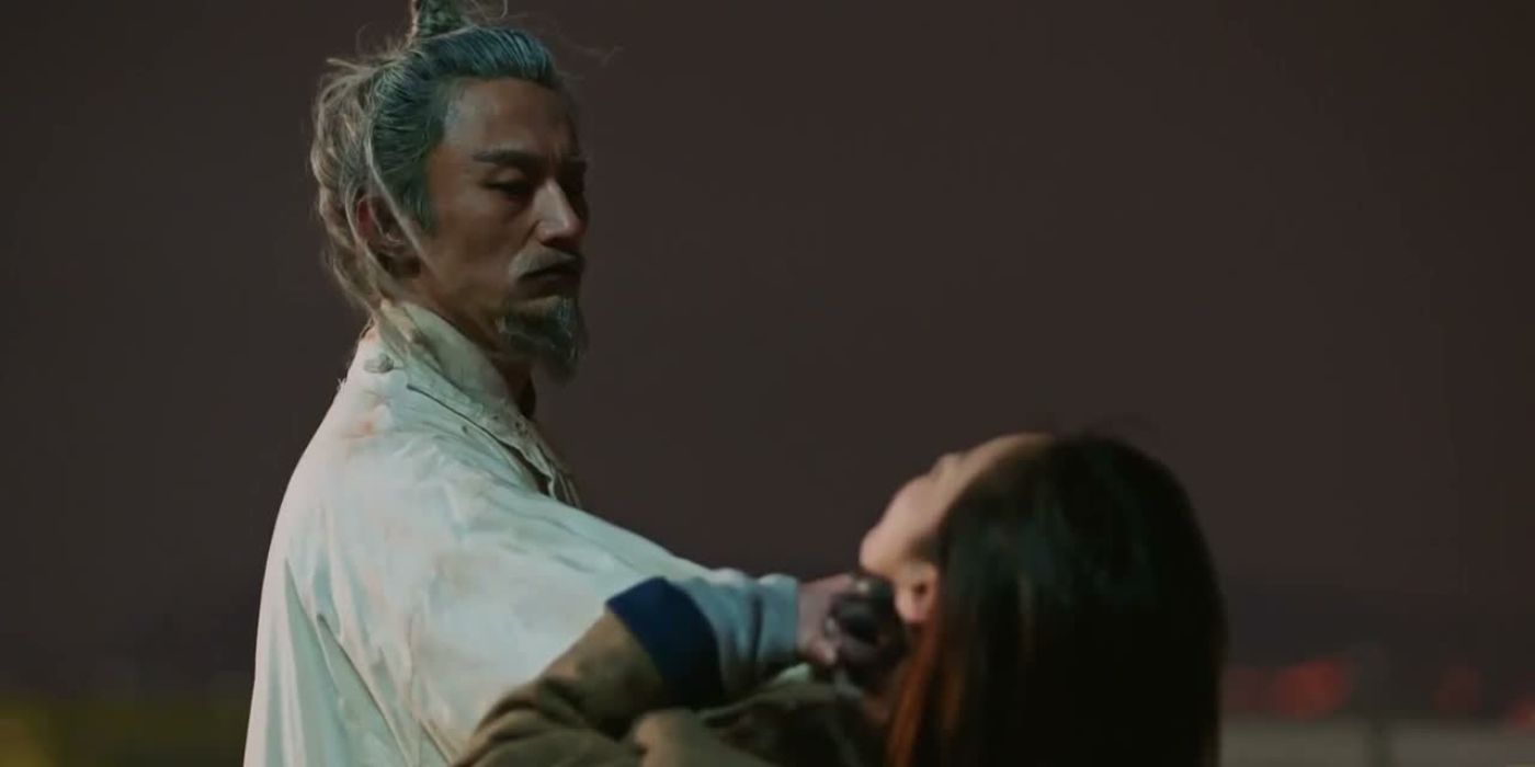 A man in white with grey hair is holding a woman by the throat and choking her down in Goblin.