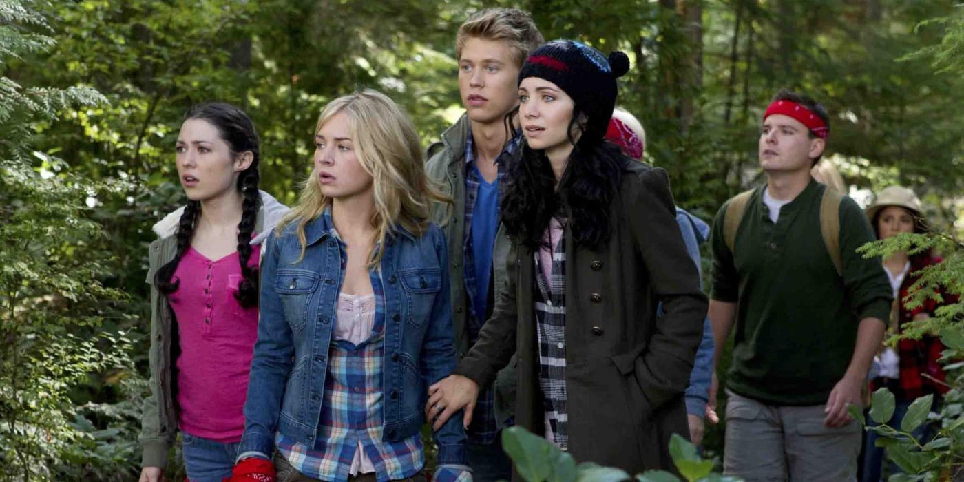 The cast stop to look at something while hiking through the woods in Life Unexpected.